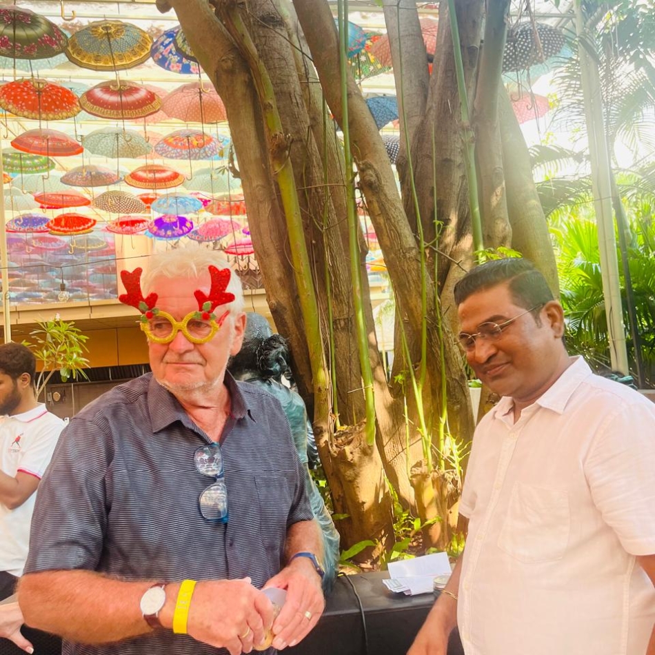 Dr. Raju Bhusanar with a patient at a community event in Calangute